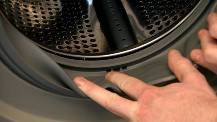 Pull the washing machine door seal back and check all the way around the inner side