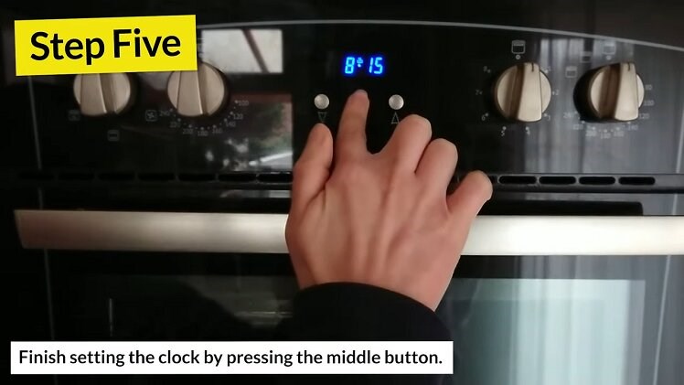 Pressing The Middle Button Beneath The Belling Oven Clock To Finish Setting The Clock