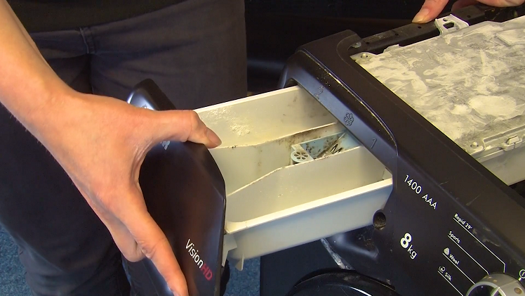 Remove the soap drawer by simply pulling it all the way out of the machine.