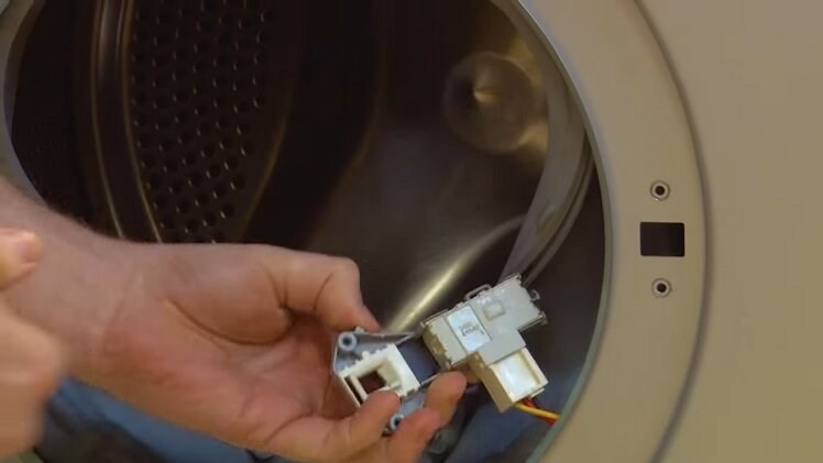 Pull the door lock out of the washing machine door, but it will still be connected by an electrical connection