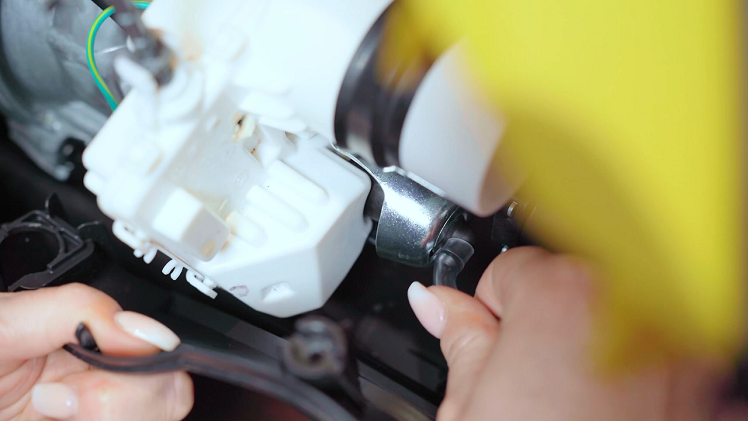 Reconnect the front casing by refitting the soap dispenser hose and mains cable inside.