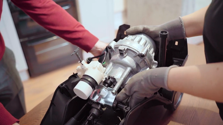 One person will firmly hold the pressure washer's main body, the other person will grab hold of the motor and work it off the pump housing.
