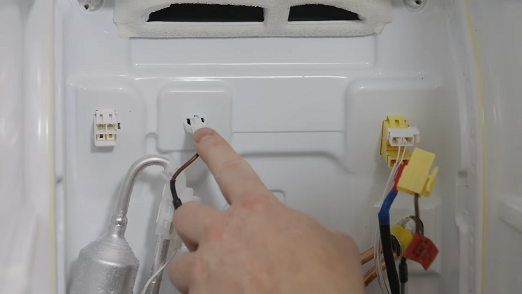 Releasing The White Left Hand Plug With A Brown Wire By Squeezing It Gently And Pulling It Free