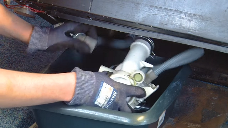 To disconnect the drain and sump hose from the drain pump, use your pliers to remove the metal clips.