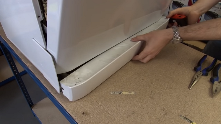 Removing The Kickplate At The Bottom Of The Dishwasher By Unscrewing The Screws Underneath