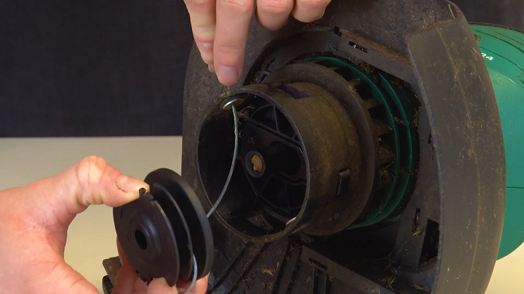 Pulling The Spool Off The Spindle And Gently Feeding Any Remaining Line Through The Outlet Holes