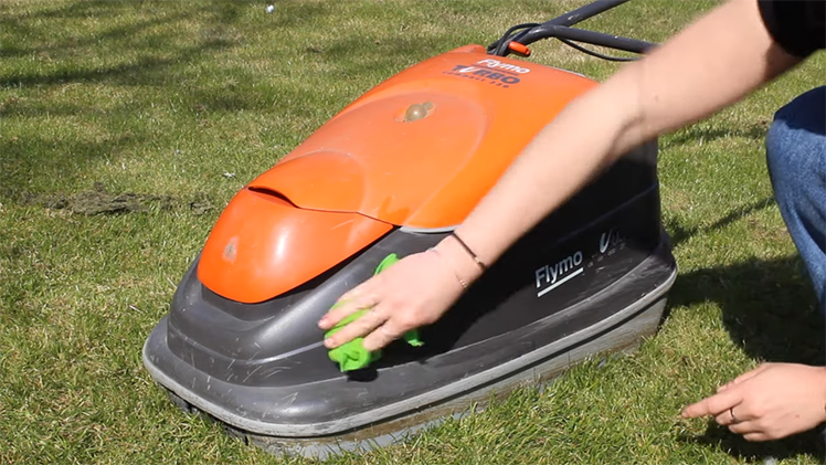 Wiping Down The Lawnmower Using A Damp, Wrung Out Cloth