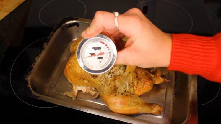 Inserting The Meat Thermometer Probe Into The Cooked Meat