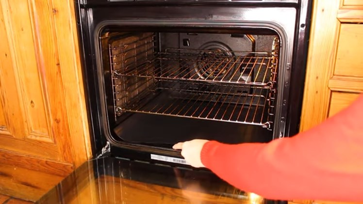 Slotting The Universal Reusable Non Stick Liner Into The Base Of The Oven