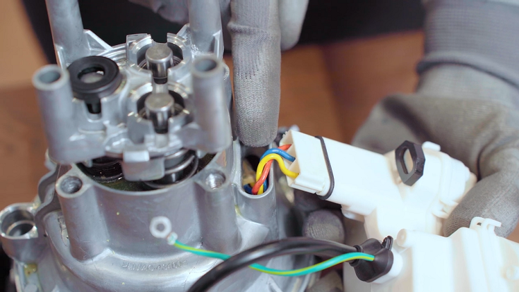 Slot the plug into the side of the motor, making sure you hold the small black gasket in place so it doesn't fall off.