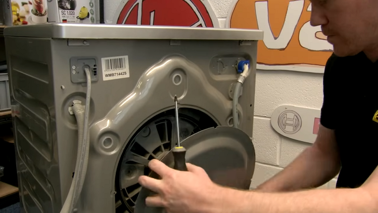 The washing machine back panel removed