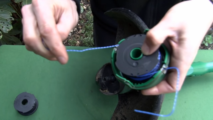 Removing Either Side Of The Line From The Spool Cleats And Feeding Them Through The Slim Eyelet Openings On Either Side Of The Cover