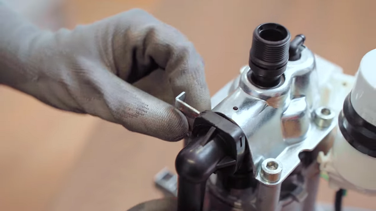 Use your flatblade screwdriver to remove the metal circlip at the top.