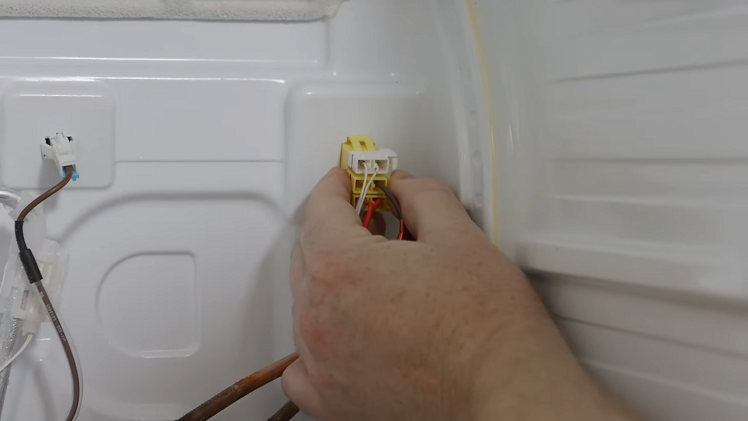 Releasing The Small Plug With The Brown Wire By Pressing The Clip On The Right Hand Side Of The Plug And Pulling It Free