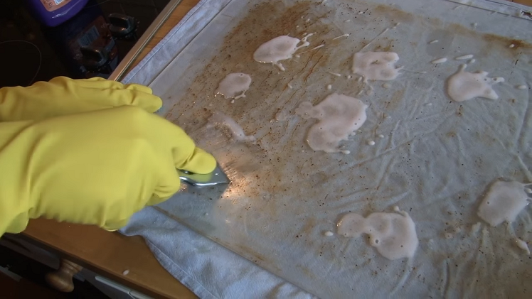 Using A Hob Scraper To Remove Thick Stains From The Inner Panels Of Glass