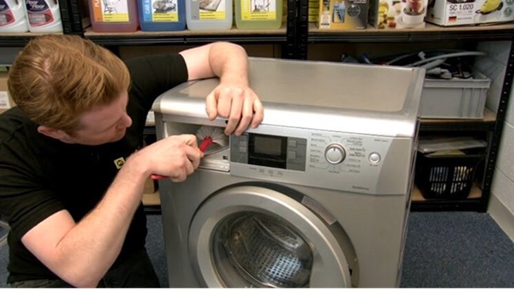 Scrub away any muck from the dispenser drawer itself with a cleaning brush