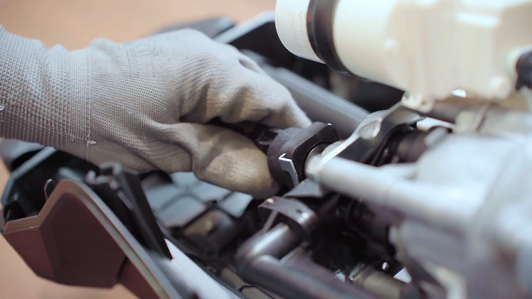 Slot the metal clip back into place on the pump housing above the motor.