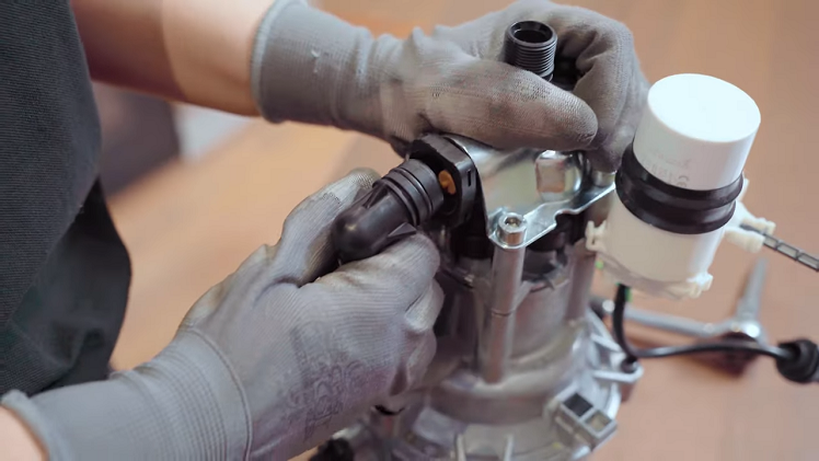 Once the clip is out, you can pull the pump feed pipe away from the pump/motor unit.