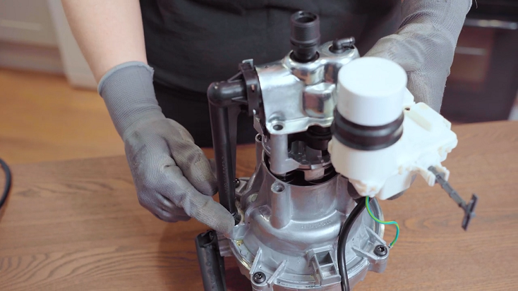 Make sure the black water feed pipe on the side is lined up with the motor opening beneath it.