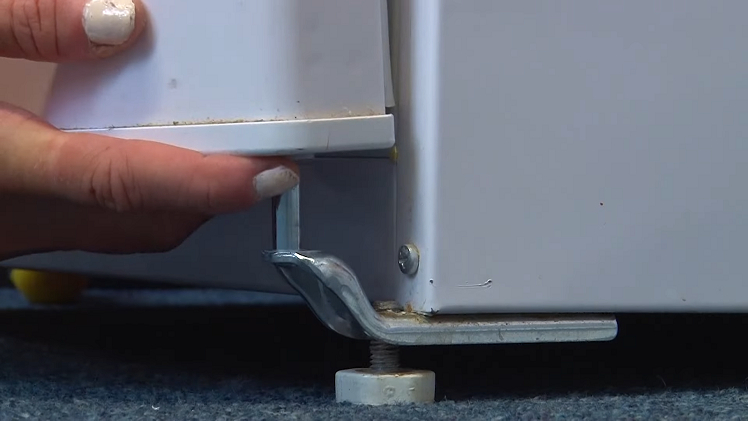 Slotting The Freezer Door Into Place On The Bottom Hinge Pin
