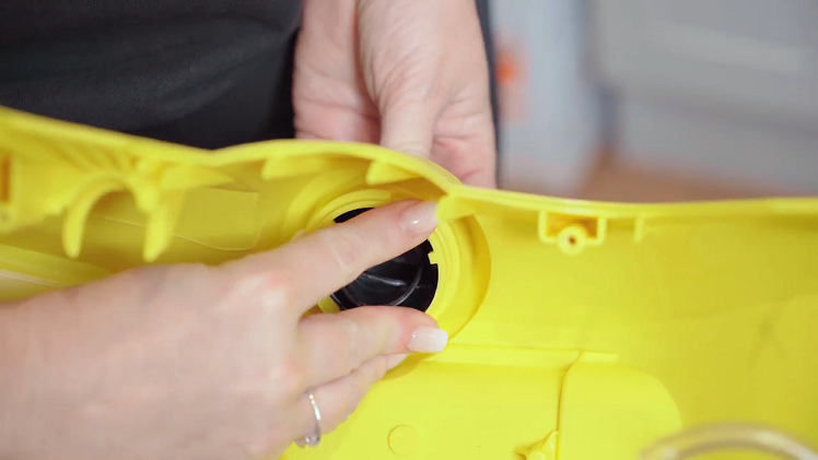 To remove the control knob, squeeze in the three small black clips that keep the knob held into place.