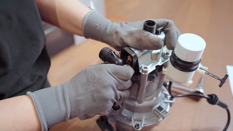 Twist the pump feed pipe to the side.