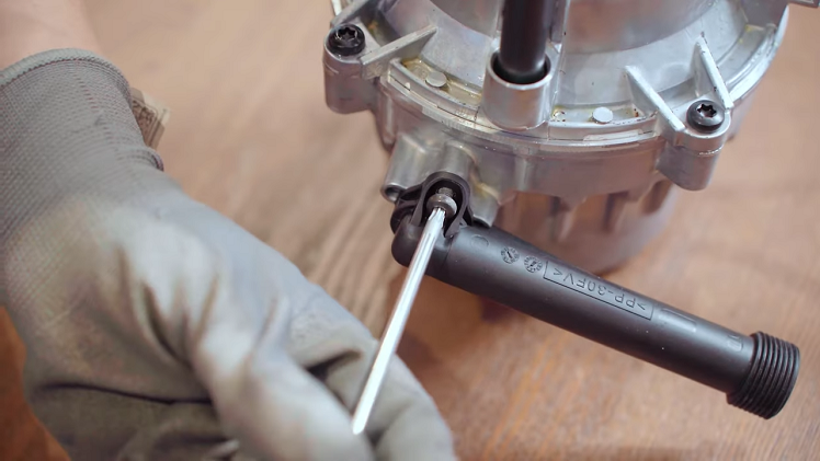 Once you've checked and replaced the seal, you can screw the water inlet pipe back onto the motor.