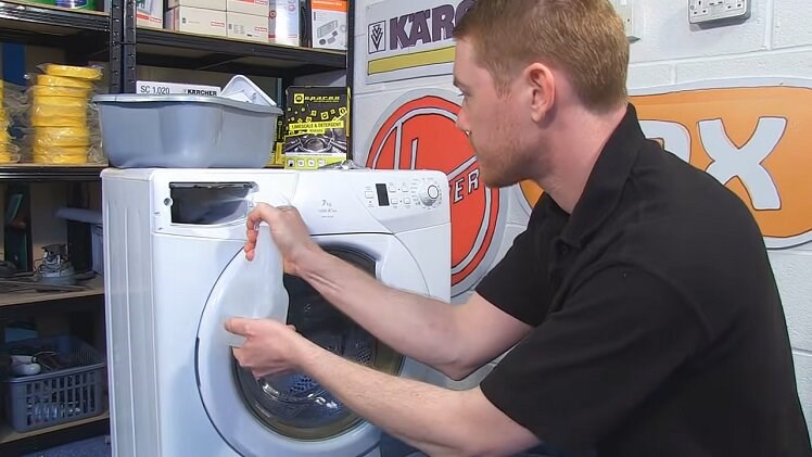 Spraying A Bottle Of Warm Water And eSpares Descaler Inside The Washing Machine Detergent Drawer Housing