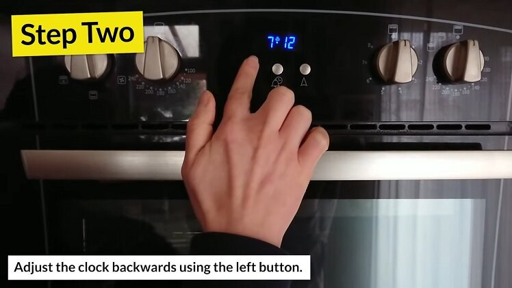 Pressing The Left Button Beneath The Belling Oven Clock To Turn The Clock Backwards