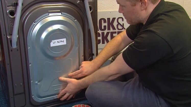 Slot the back panel into place at the back of the washing machine