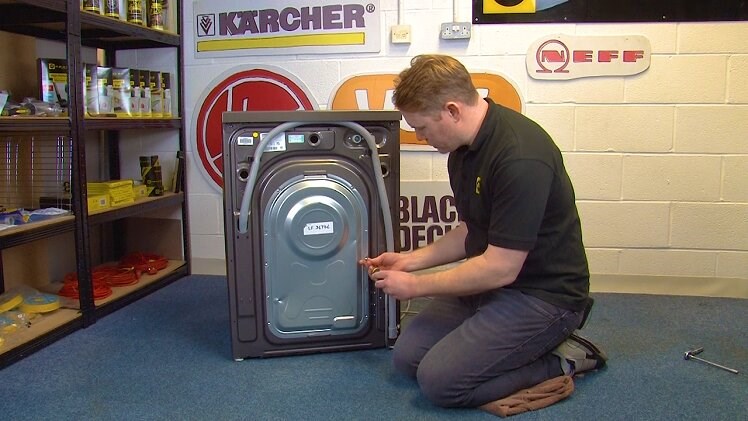 Use a Phillips screwdriver to remove all the screws that hold the washing machine back panel in place