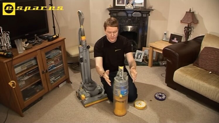 Remove the canister from the vacuum cleaner by pressing the release clip at the top