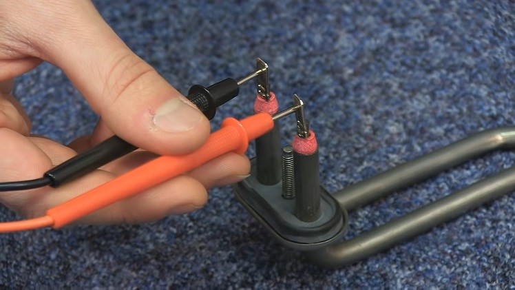 Placing The Probes Of A Multimeter On The Electrical Terminals On The Heater