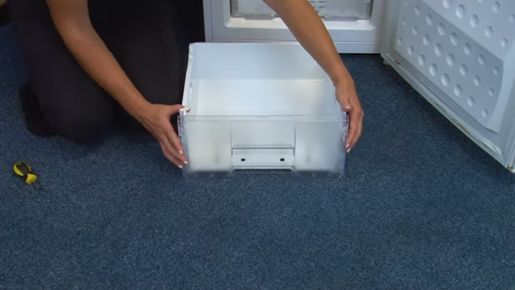 Placing The New Freezer Drawer Front Onto The Drawer And Clicking All Four Side Tabs Into Place