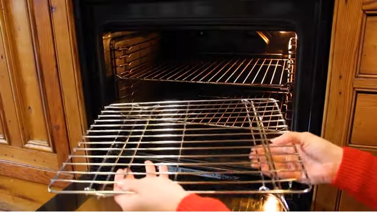 Folding The Legs On Each Side Of The Universal Base Oven Shelf