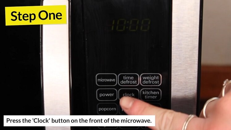 Press the clock button on the front of your Kenwood microwave to put it into clock-changing mode