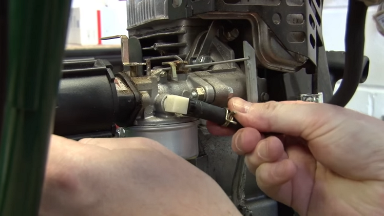 Reconnecting The Fuel Line On The Petrol Lawnmower