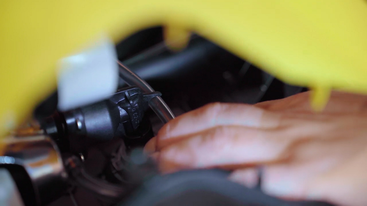 To fully free the casing, first reach inside and pull the soap dispenser hose out of its inner clip.