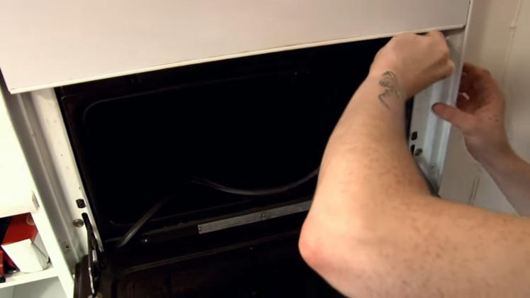 Removing The Hooks On Each Corner Of The Lower Oven And Pulling The Door Seal Away