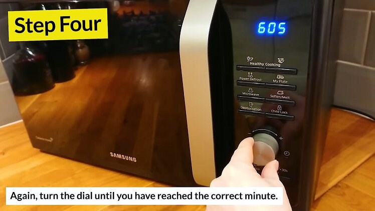 Turning The Large Circular Dial To Change The Minutes Shown On The Samsung Microwave Digital Clock